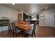 Dining room area with a hardwood table and modern decor, and a beautiful view of the kitchen area at 11250 Florence St # 17D, Commerce City, CO 80640