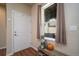 Cozy entryway with a white door, window with curtains, decorative bench, and hardwood floors, creating a warm welcome at 11250 Florence St # 17D, Commerce City, CO 80640