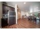 Spacious living room and dining area features hardwood floors and contemporary furnishings for a stylish and inviting atmosphere at 11250 Florence St # 17D, Commerce City, CO 80640