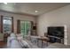 Comfortable living area with sliding doors to the balcony, wood floors, and a stylish, neutral color palette at 11250 Florence St # 17D, Commerce City, CO 80640