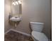 A powder room with pedestal sink and tile floors at 11250 Florence St # 17D, Commerce City, CO 80640