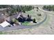 An aerial view showcases this beautiful single-Gathering home and its well-manicured lot and long driveway at 12984 Crowfoot Springs Rd, Larkspur, CO 80118