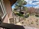 A tiered backyard with a metal fence, stone walkways, and mature trees, providing a private outdoor space at 12984 Crowfoot Springs Rd, Larkspur, CO 80118