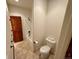 A tiled bathroom featuring a shower/tub combo and a toilet with two rolls of toilet paper on it at 12984 Crowfoot Springs Rd, Larkspur, CO 80118