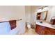 A clean half bathroom featuring wooden cabinets, a white sink, and a matching mirror at 12984 Crowfoot Springs Rd, Larkspur, CO 80118