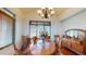 This formal dining room is ready for entertaining, featuring a stylish chandelier and built-in shelving at 12984 Crowfoot Springs Rd, Larkspur, CO 80118