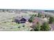 The rear of this home features solar panels, a full-length patio, and mature trees in a large yard at 12984 Crowfoot Springs Rd, Larkspur, CO 80118