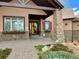 A front exterior shot highlights a stone entryway, a yellow front door and rock accents at 12984 Crowfoot Springs Rd, Larkspur, CO 80118