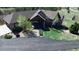 This high angle shows this home's attractive landscaping, including mature trees and a circular driveway at 12984 Crowfoot Springs Rd, Larkspur, CO 80118