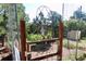 An ornate garden gate invites you to a serene and thriving outdoor space with thriving greenery at 12984 Crowfoot Springs Rd, Larkspur, CO 80118