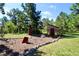 A charming shed is complemented by yellow chairs, creating a serene outdoor retreat at 12984 Crowfoot Springs Rd, Larkspur, CO 80118