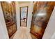 Hallway with wooden doors leading to a bedroom with neutral walls and carpet at 12984 Crowfoot Springs Rd, Larkspur, CO 80118