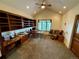 Bright home office featuring built-in bookshelves, a ceiling fan, and a stained glass window at 12984 Crowfoot Springs Rd, Larkspur, CO 80118
