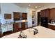 Charming kitchen features a white island sink, custom cabinets, and recessed lighting at 12984 Crowfoot Springs Rd, Larkspur, CO 80118