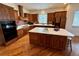Charming kitchen featuring a center island, custom cabinets, and recessed lighting at 12984 Crowfoot Springs Rd, Larkspur, CO 80118