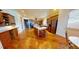 Spacious kitchen featuring wood cabinets, a center island, and hardwood floors at 12984 Crowfoot Springs Rd, Larkspur, CO 80118