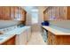 Bright laundry room with cabinets, counter space, sink, and modern appliances at 12984 Crowfoot Springs Rd, Larkspur, CO 80118