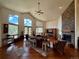 Spacious living room with a stone fireplace, hardwood floors, and large picture windows at 12984 Crowfoot Springs Rd, Larkspur, CO 80118