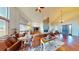 Open living room with a stone fireplace, hardwood floors, and high ceilings at 12984 Crowfoot Springs Rd, Larkspur, CO 80118