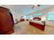 Spacious main bedroom featuring a fan, dresser, and windows with blinds at 12984 Crowfoot Springs Rd, Larkspur, CO 80118