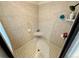 Bathroom shower with tiled walls, soap and shampoo holders, and showerhead at 12984 Crowfoot Springs Rd, Larkspur, CO 80118