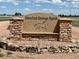 The stone Crowfoot Springs Ranch sign has stone trim and is surrounded by landscaping at 12984 Crowfoot Springs Rd, Larkspur, CO 80118