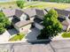 Aerial view of a tan townhome with a two-car garage, situated in a neighborhood with mature trees and green spaces at 211 Rockview Dr, Superior, CO 80027