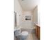 Bathroom featuring a soaking tub, toilet and vanity with wood cabinets at 211 Rockview Dr, Superior, CO 80027