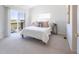 Bright bedroom with sliding glass doors to a balcony with water views at 211 Rockview Dr, Superior, CO 80027