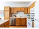 Kitchen with light wood cabinets, stainless steel dishwasher, and white appliances at 211 Rockview Dr, Superior, CO 80027