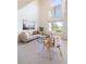 Bright living room with vaulted ceilings, modern furniture, and large windows overlooking greenery at 211 Rockview Dr, Superior, CO 80027