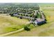 Aerial view of a community of homes nestled among mature trees, and overlooking scenic green space at 211 Rockview Dr, Superior, CO 80027