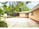 A spacious backyard featuring a brick house, a large patio, and mature trees at 5099 S Linden Dr, Englewood, CO 80110