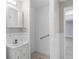 Functional bathroom features a tiled shower stall, vanity with a mirrored cabinet, and tiled walls at 5099 S Linden Dr, Englewood, CO 80110