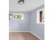 Bright bedroom with hardwood floors and two windows offering natural light at 5099 S Linden Dr, Englewood, CO 80110