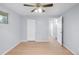 Bright bedroom boasts hardwood floors, a ceiling fan, a closet, and an open doorway to another room at 5099 S Linden Dr, Englewood, CO 80110