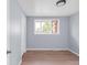 Inviting bedroom features hardwood floors, a closet, large window views, and neutral wall color at 5099 S Linden Dr, Englewood, CO 80110