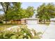 Charming front exterior featuring a two-car garage, brick accents, and a well-manicured lawn at 5099 S Linden Dr, Englewood, CO 80110