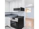 Well-lit kitchen features modern appliances and white cabinets, with an adjacent open-concept room at 5099 S Linden Dr, Englewood, CO 80110