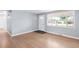 Bright living room featuring hardwood floors and a large window for natural light at 5099 S Linden Dr, Englewood, CO 80110