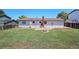 Spacious backyard featuring green grass, a brick fire pit and neutral colored siding at 16720 E Layton Ave, Aurora, CO 80015
