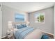 Comfortable bedroom with a plush bed, neutral walls, and a bright window view at 16720 E Layton Ave, Aurora, CO 80015
