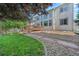 Backyard with a deck, lush grass, stone path, and plenty of privacy for outdoor enjoyment at 6808 Silverleaf Ave, Firestone, CO 80504