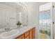 Bright bathroom features dual sinks, oak cabinets, and a colorful shower curtain at 6808 Silverleaf Ave, Firestone, CO 80504