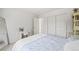 Bright bedroom with a floral-patterned bed, mirrored closet, and a vanity desk at 6808 Silverleaf Ave, Firestone, CO 80504
