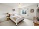 Comfortable bedroom featuring neutral decor, soft lighting, and a large window at 6808 Silverleaf Ave, Firestone, CO 80504