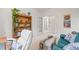 Bright office area features a bookcase, sofa and french doors leading to other rooms at 6808 Silverleaf Ave, Firestone, CO 80504