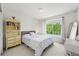 Cozy bedroom with a floral-patterned bed, sunny window, and vintage-style vanity at 6808 Silverleaf Ave, Firestone, CO 80504