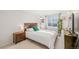 Bright bedroom features a queen bed, nightstand, and window, creating a relaxing atmosphere at 6808 Silverleaf Ave, Firestone, CO 80504