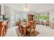 Bright dining room with large windows, a dining table, and stylish decor at 6808 Silverleaf Ave, Firestone, CO 80504